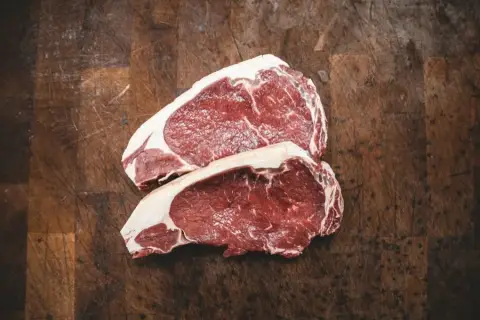 Ribeye steaks and cuts from the fell-grazed beef box on a butcher's block