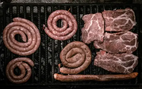 Coils of Cumberland sausage laid out on the butchery counter