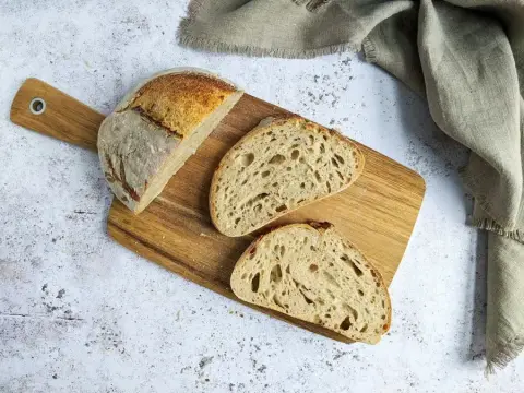 A sliced Oakhowe sourdough loaf on a wooden board
